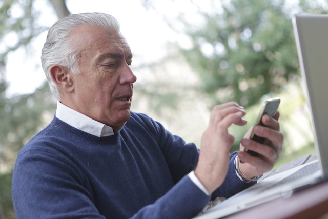 an elderly person using a cell phone